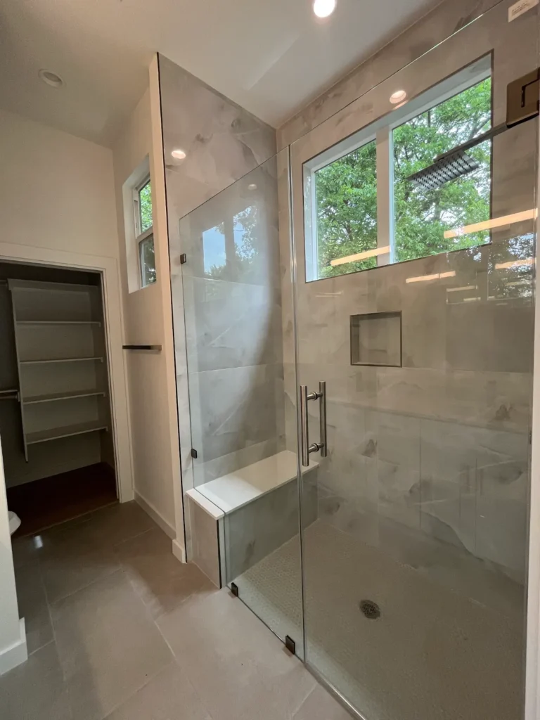 Walk-in glass shower in a new ADU bathroom at 500 Capitol Drive, Austin TX