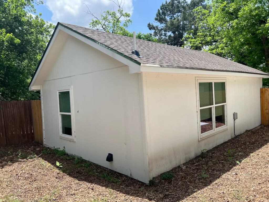 Exterior of a converted garage ADU with new windows at 500 Capitol Drive, Austin TX