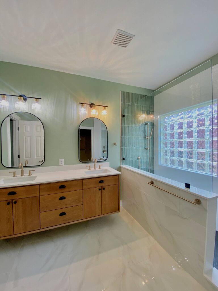 Bathroom remodel with wood vanity and glass shower in Round Rock TX
