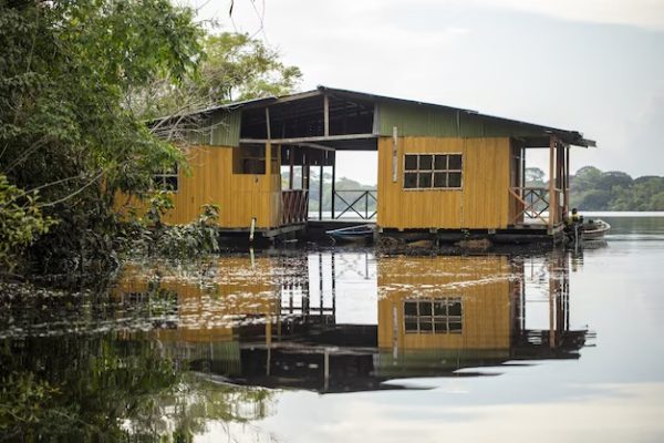 imgi_114_old-weathered-yellow-wooden-cabin-by-lake-surrounded-by-beautiful-greenery_181624-24861